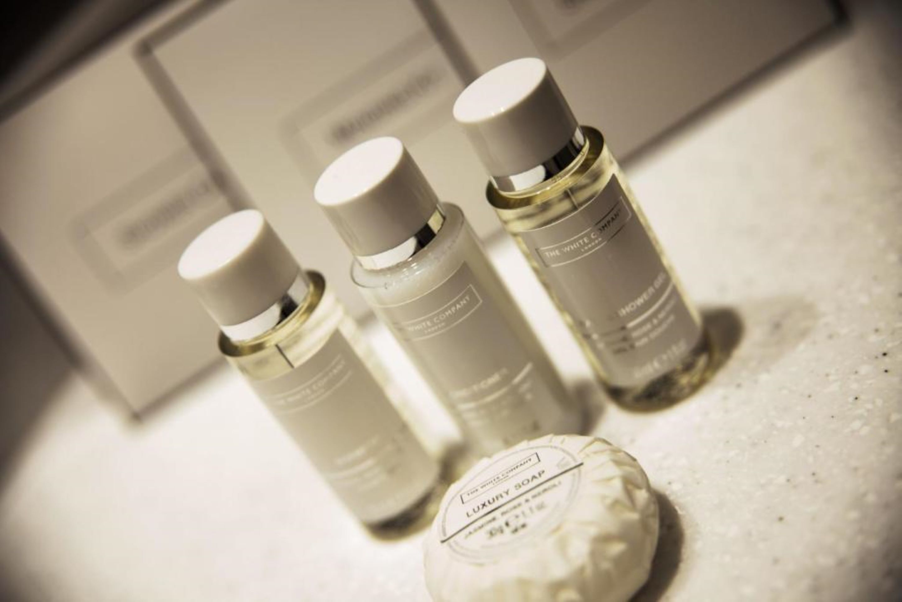 designer toiletries, hair dryer, towels