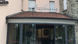 A building with a sign reading "La Corte di" above the entrance. - La Torretta (Castel San Pietro Terme)