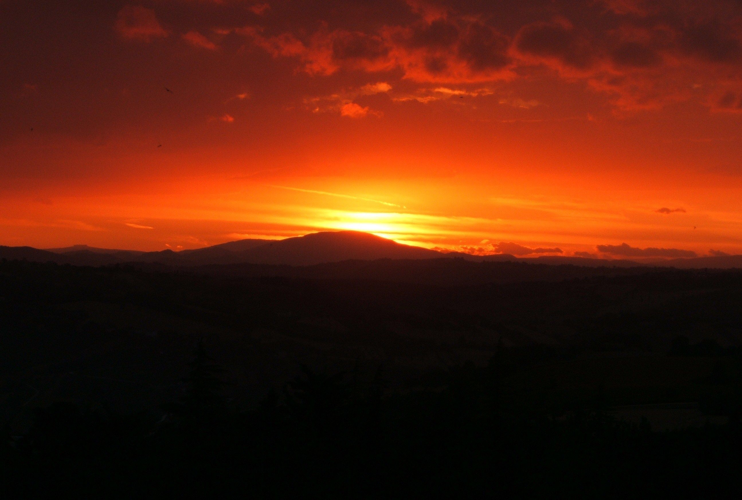 A sunset over a mountainous landscape.