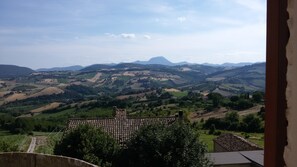 A rural landscape with rolling hills and a distant mountain. - Relais Del Borgo Hotel e Spa (Staffolo)