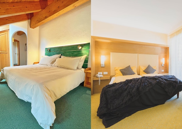 Ein Hotelzimmer mit einem großen Bett, einem hölzernen Kopfteil, einem Nachttisch mit Lampe und einem Telefon.