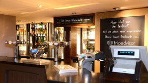 A bar area with multiple beer taps, a cash register, and a chalkboard with feedback instructions. - Unicorn, Gunthorpe by Marston's Inns (Nottingham)