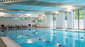 A swimming pool with clear lanes, large windows, and a modern ceiling design. - Phyllis Court Members Club (Henley-on-Thames)