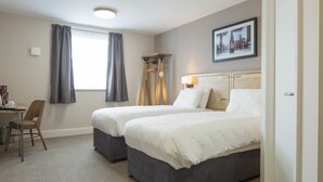 A hotel room with two beds, a desk, and a chair. - Green Lodge, Wirral by Marston's Inns (Wirral)