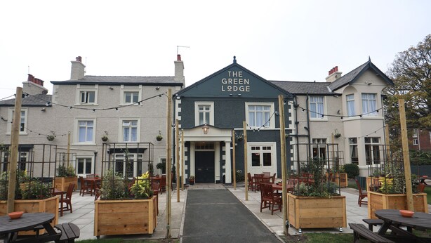 A building labeled "The Green Lodge" with outdoor seating and planters. - Green Lodge, Wirral by Marston's Inns (Wirral)