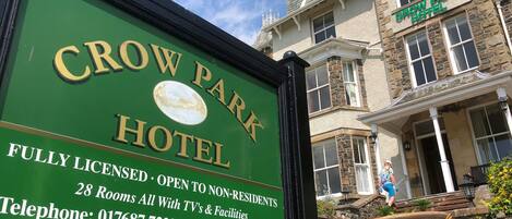 A sign for the Crow Park Hotel, indicating it is fully licensed, open to non-residents, has 28 rooms with TV and facilities, and a car park at the rear.