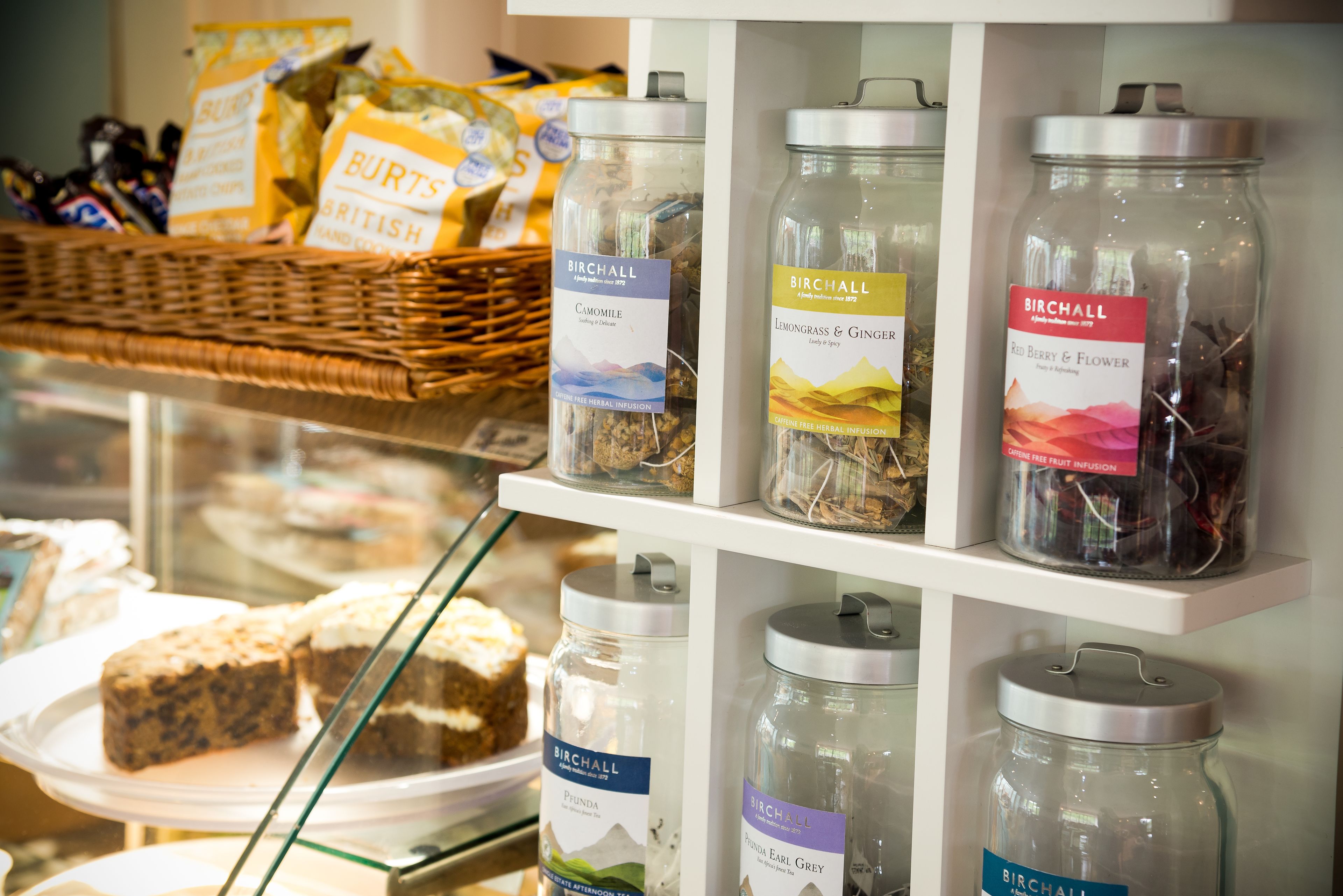 A display of herbal infusions and snacks in a store.