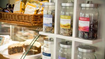 A display of herbal infusions and snacks in a store.