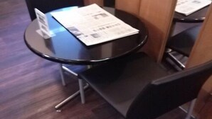 A small, round table with a menu on it, surrounded by black chairs. - Hotel Select Inn Nagano (Nagano)