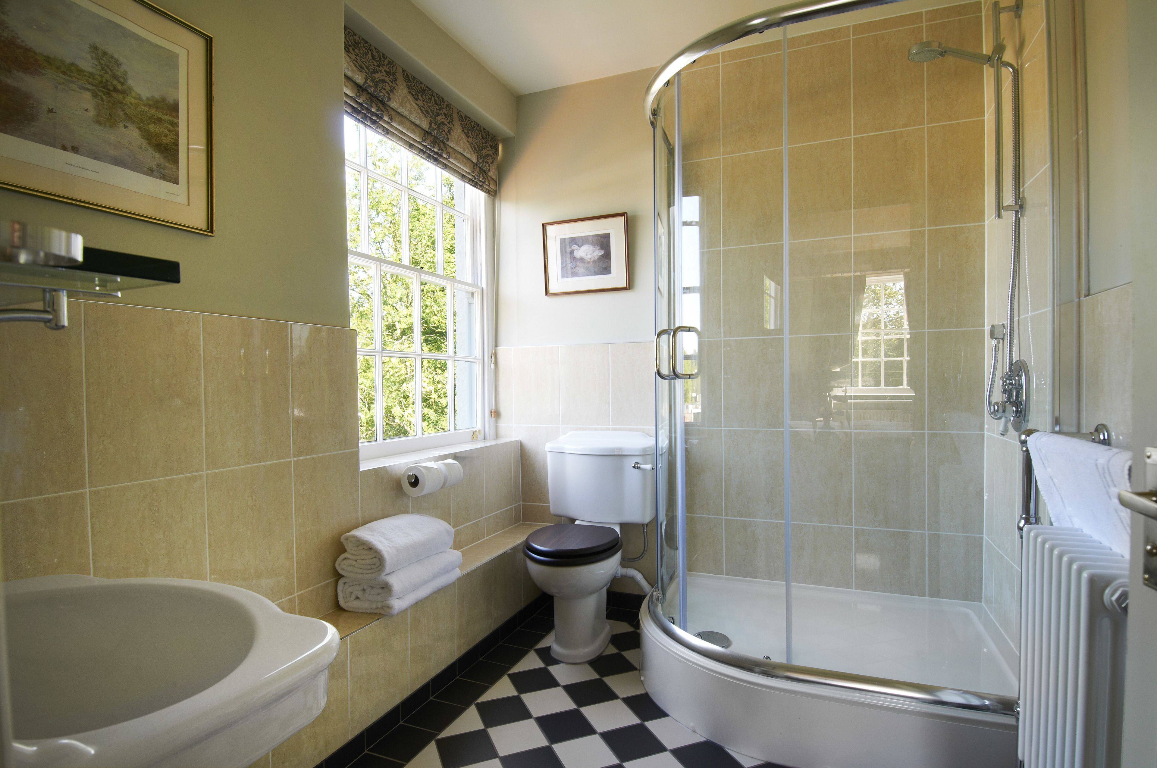 A bathroom with a bathtub, toilet, and shower.
