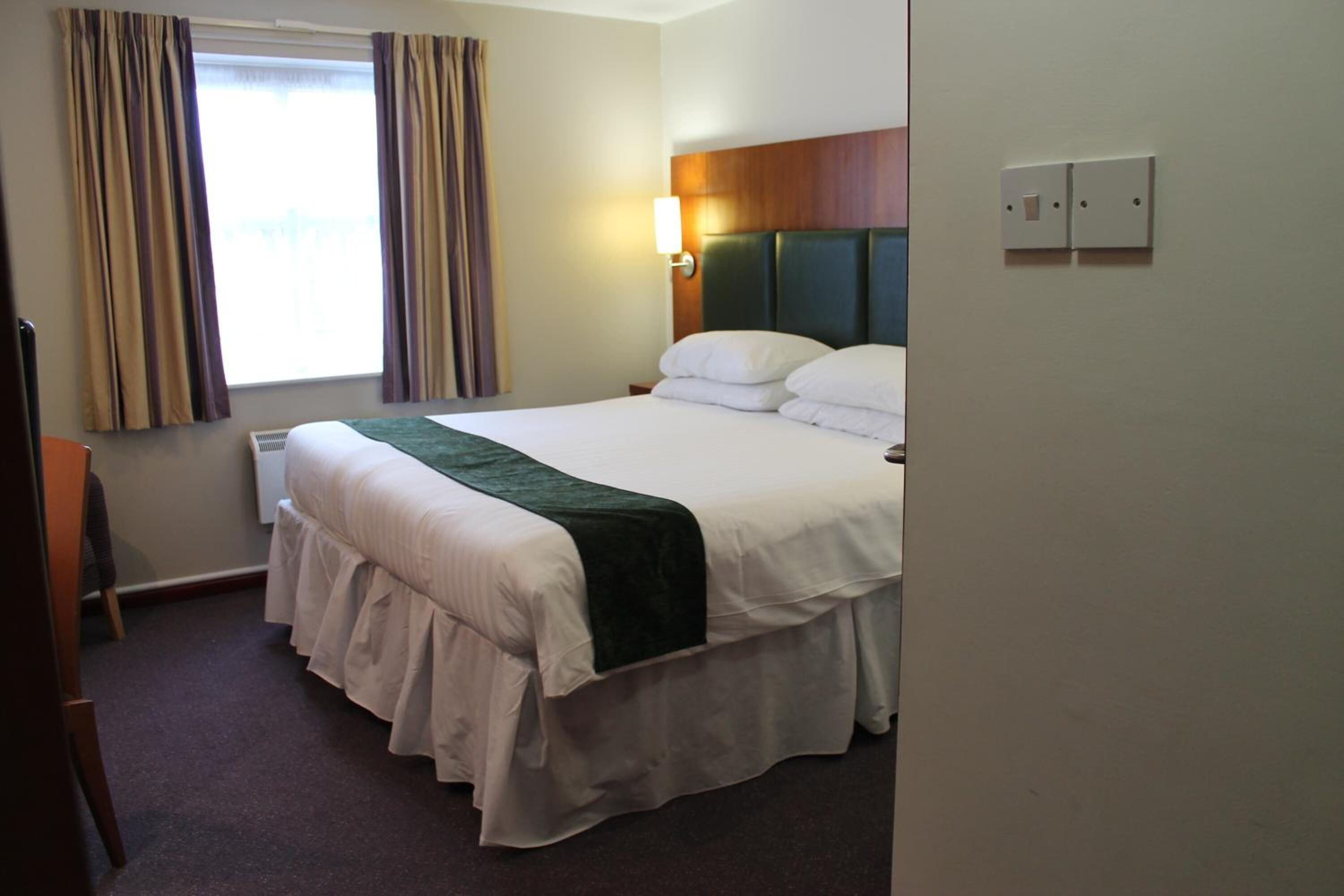 premium bedding, desk, laptop workspace, blackout curtains