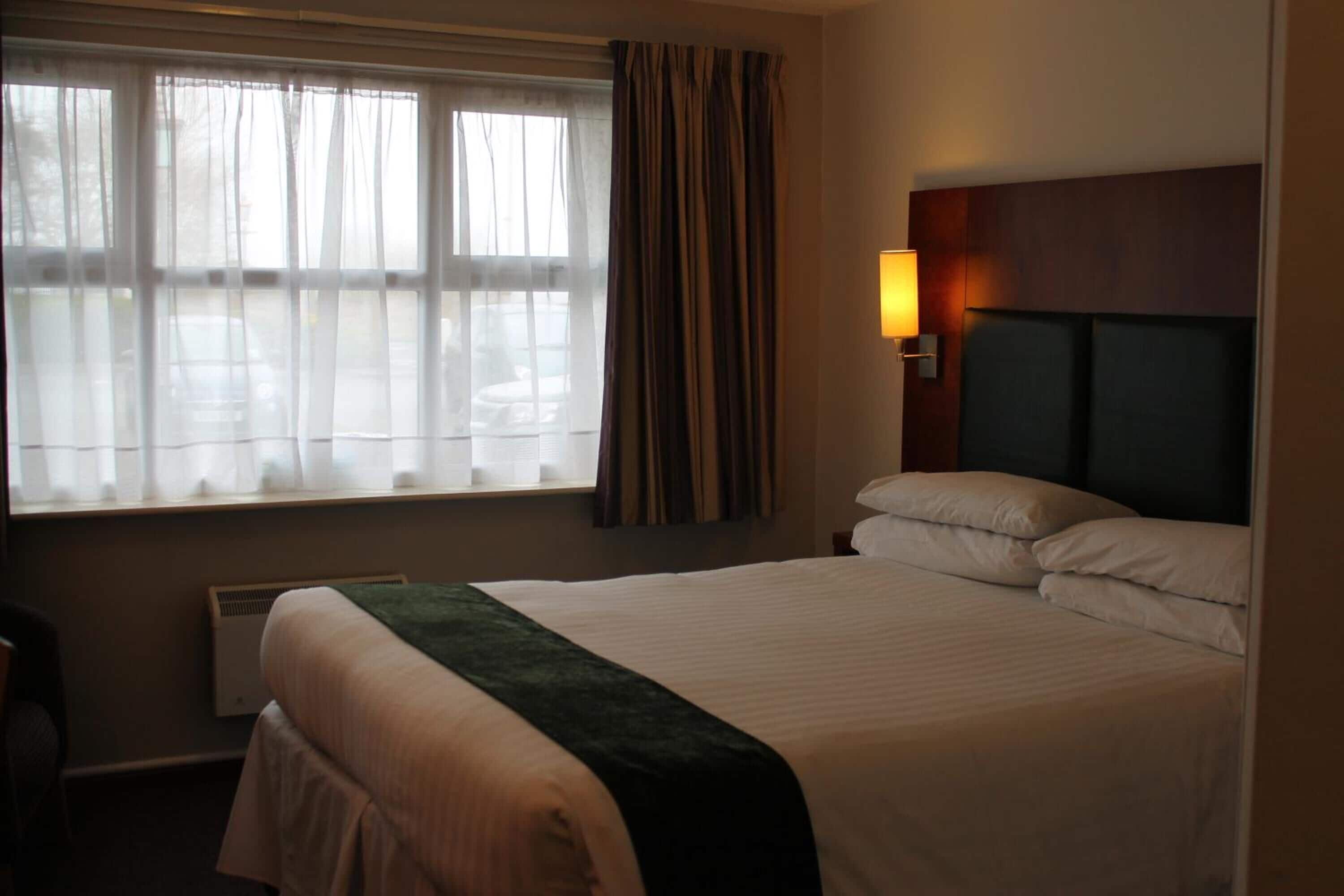 premium bedding, desk, laptop workspace, blackout curtains