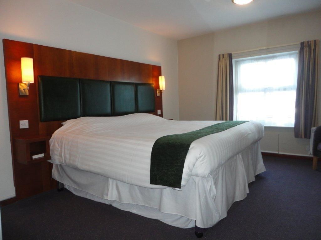 Premium bedding, desk, laptop workspace, blackout drapes