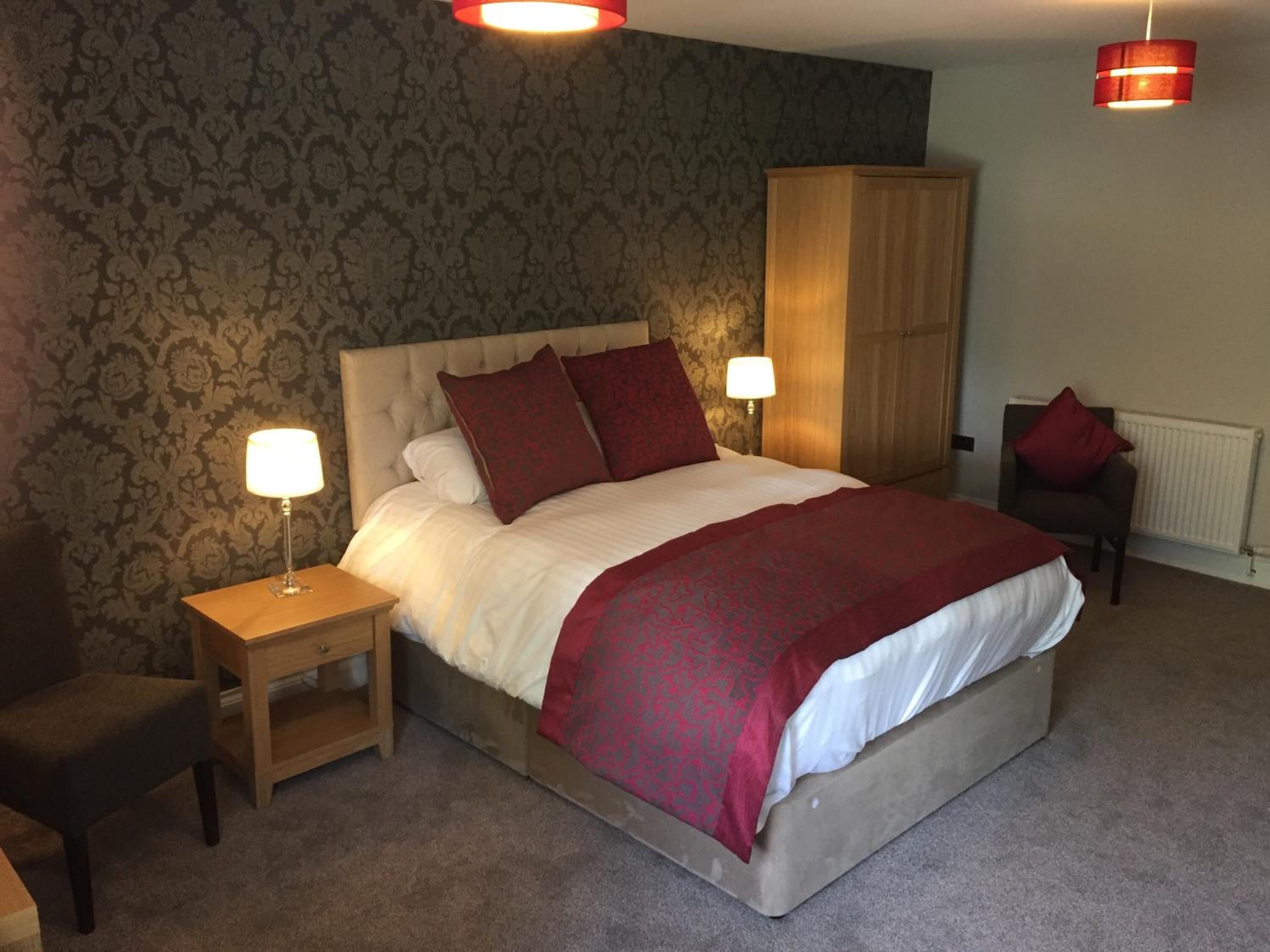 Premium bedding, desk, laptop workspace, blackout drapes