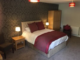 Premium bedding, desk, laptop workspace, blackout drapes