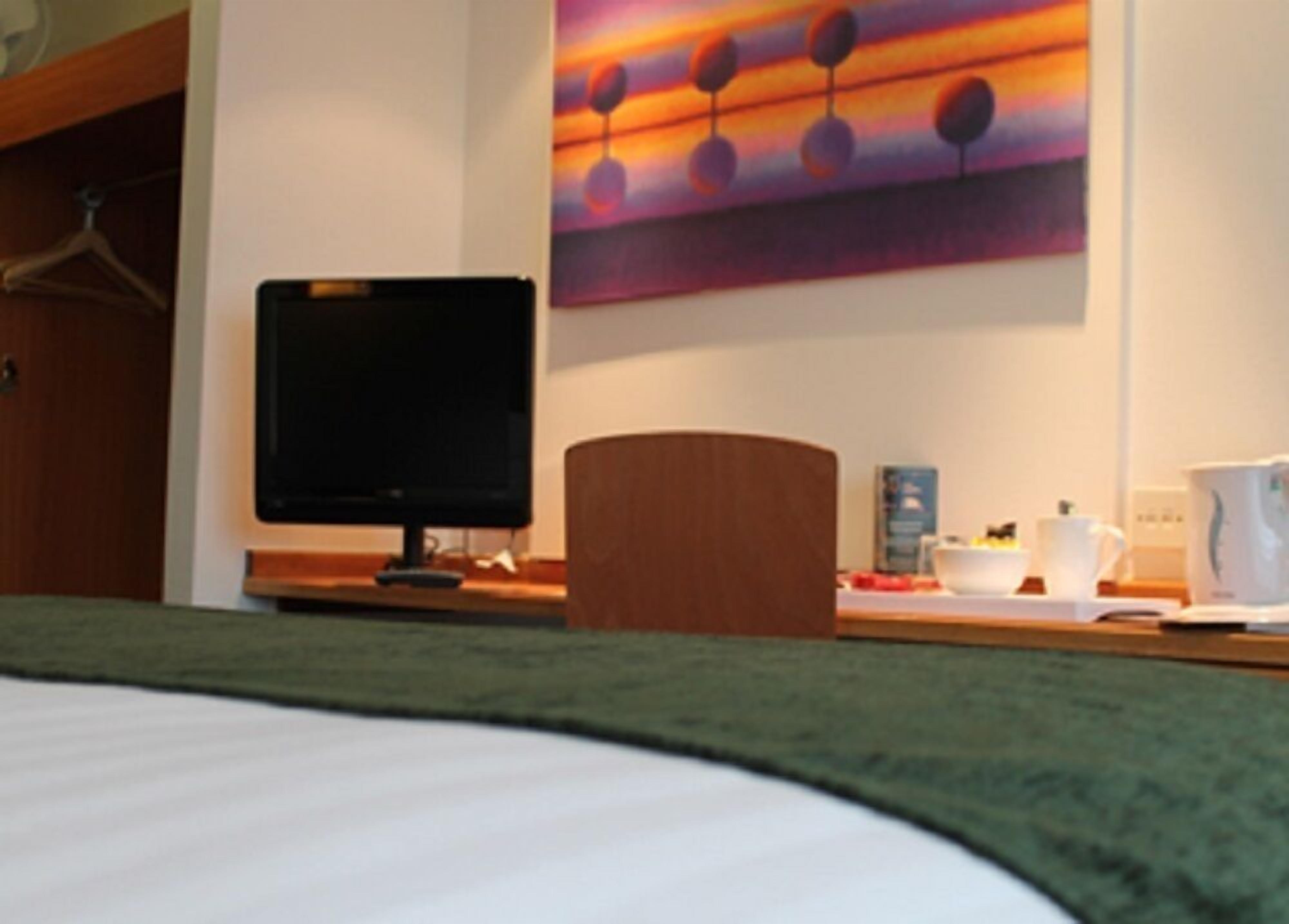 premium bedding, desk, laptop workspace, blackout curtains