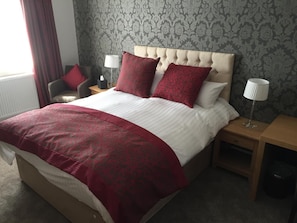 Premium bedding, desk, laptop workspace, blackout curtains