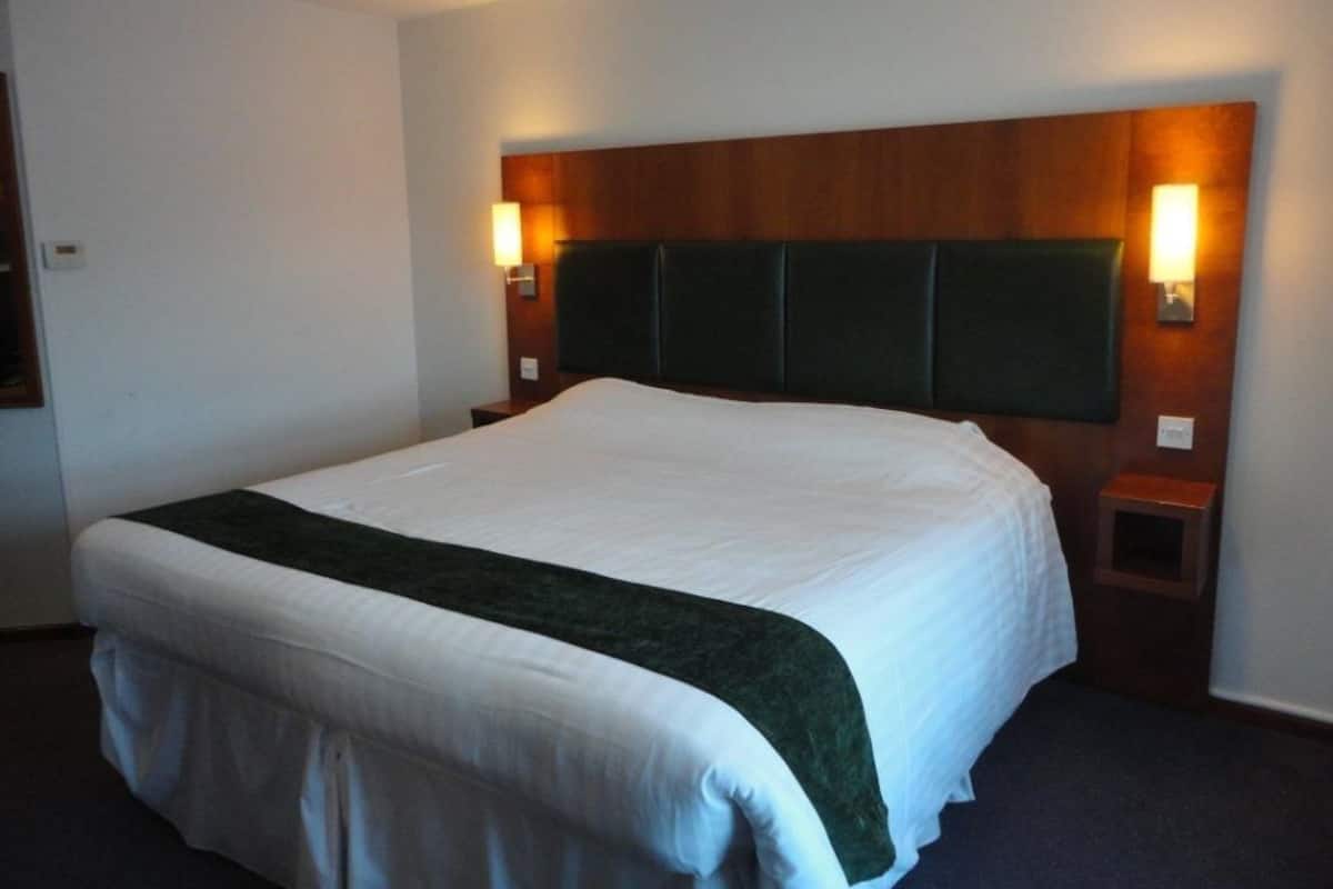 Premium bedding, desk, laptop workspace, blackout drapes