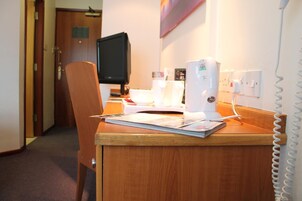 Premium bedding, desk, laptop workspace, blackout drapes