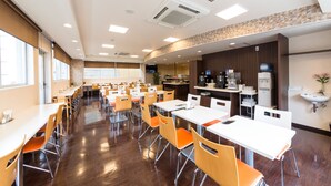 A spacious dining area with multiple tables and chairs, a kitchen counter, and a sink. - Sanco Inn Shizuoka Kitaguchi (Shizuoka)