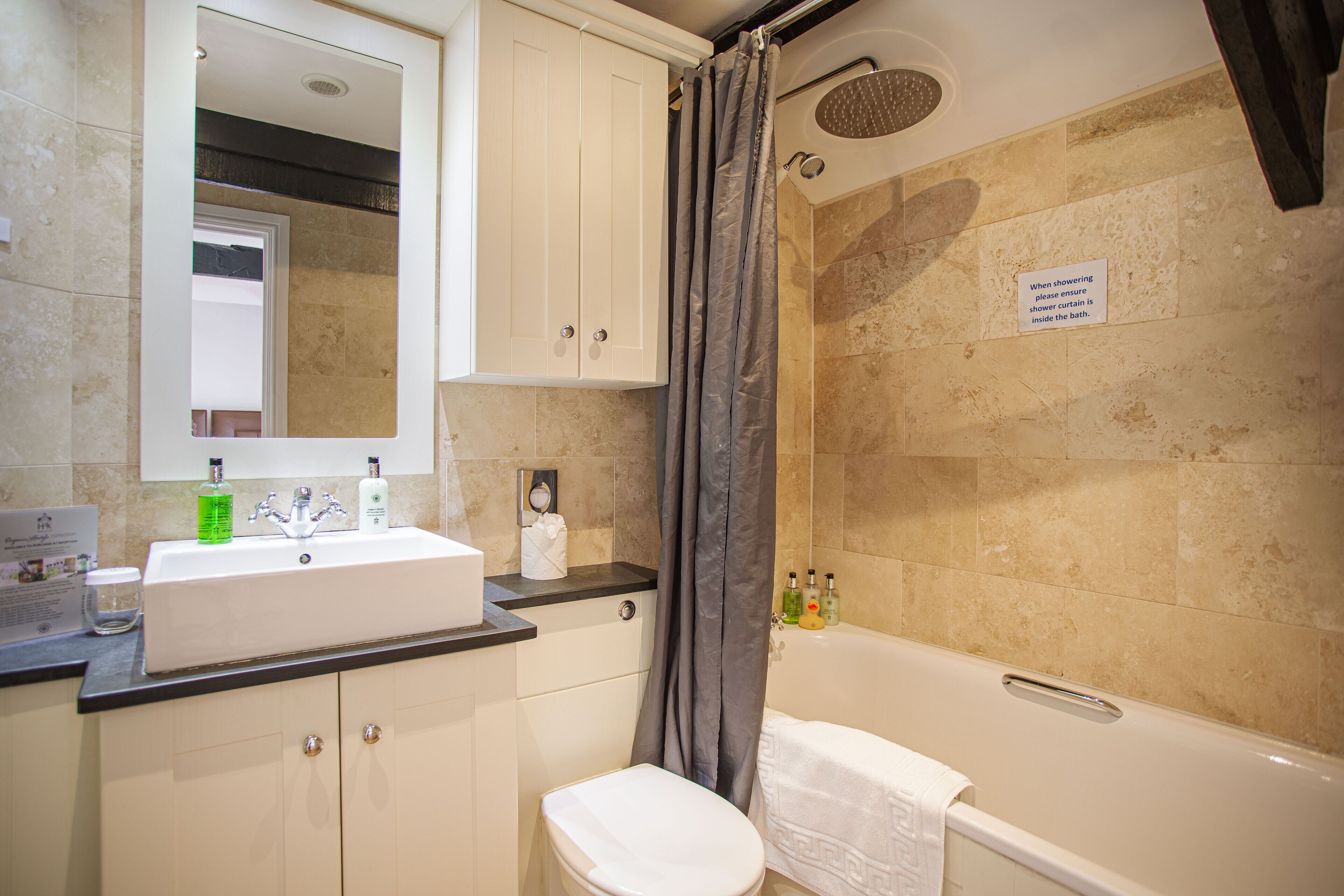 A bathroom with a sink, toilet, and bathtub.