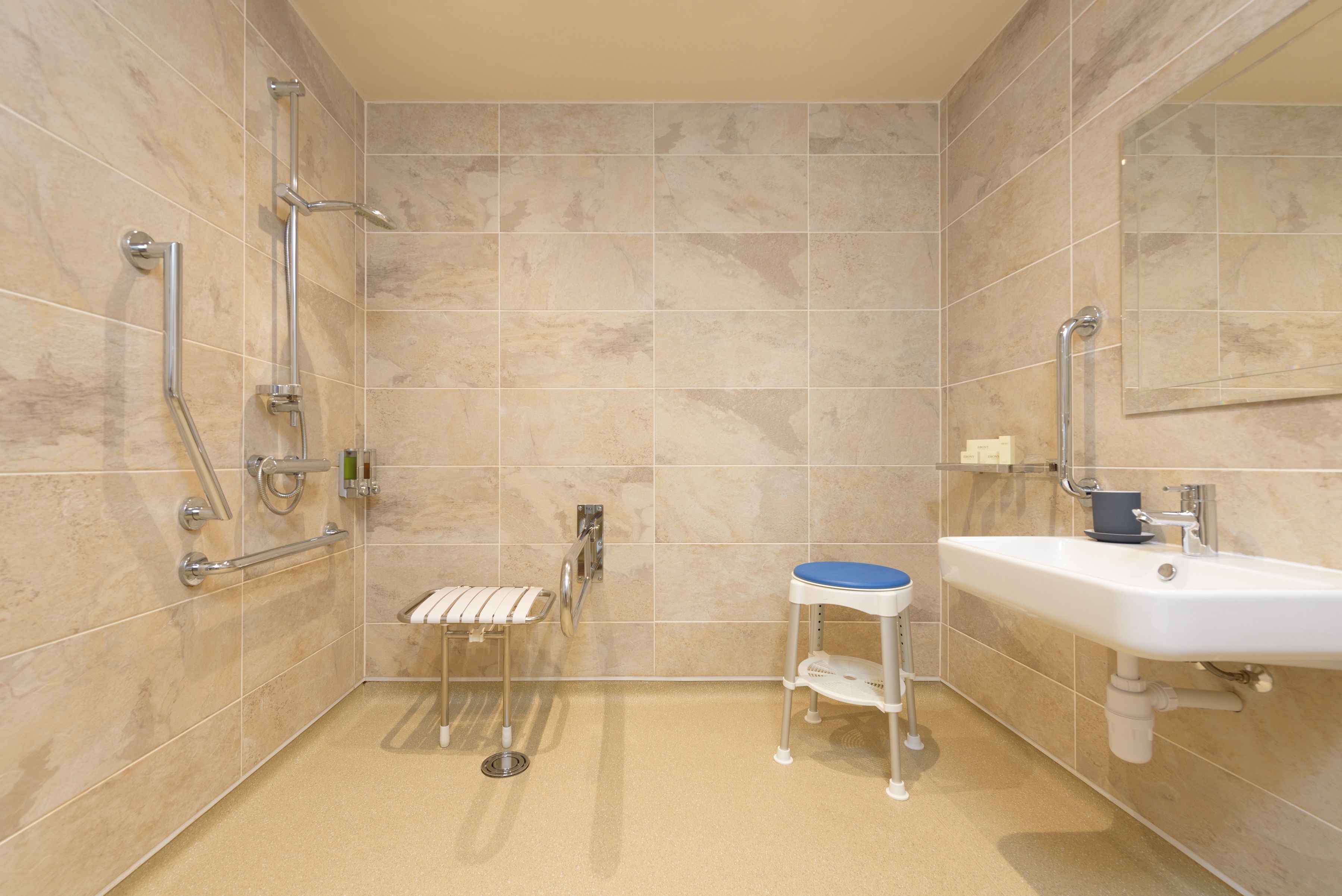 A bathroom with a shower, a sink, and a toilet.