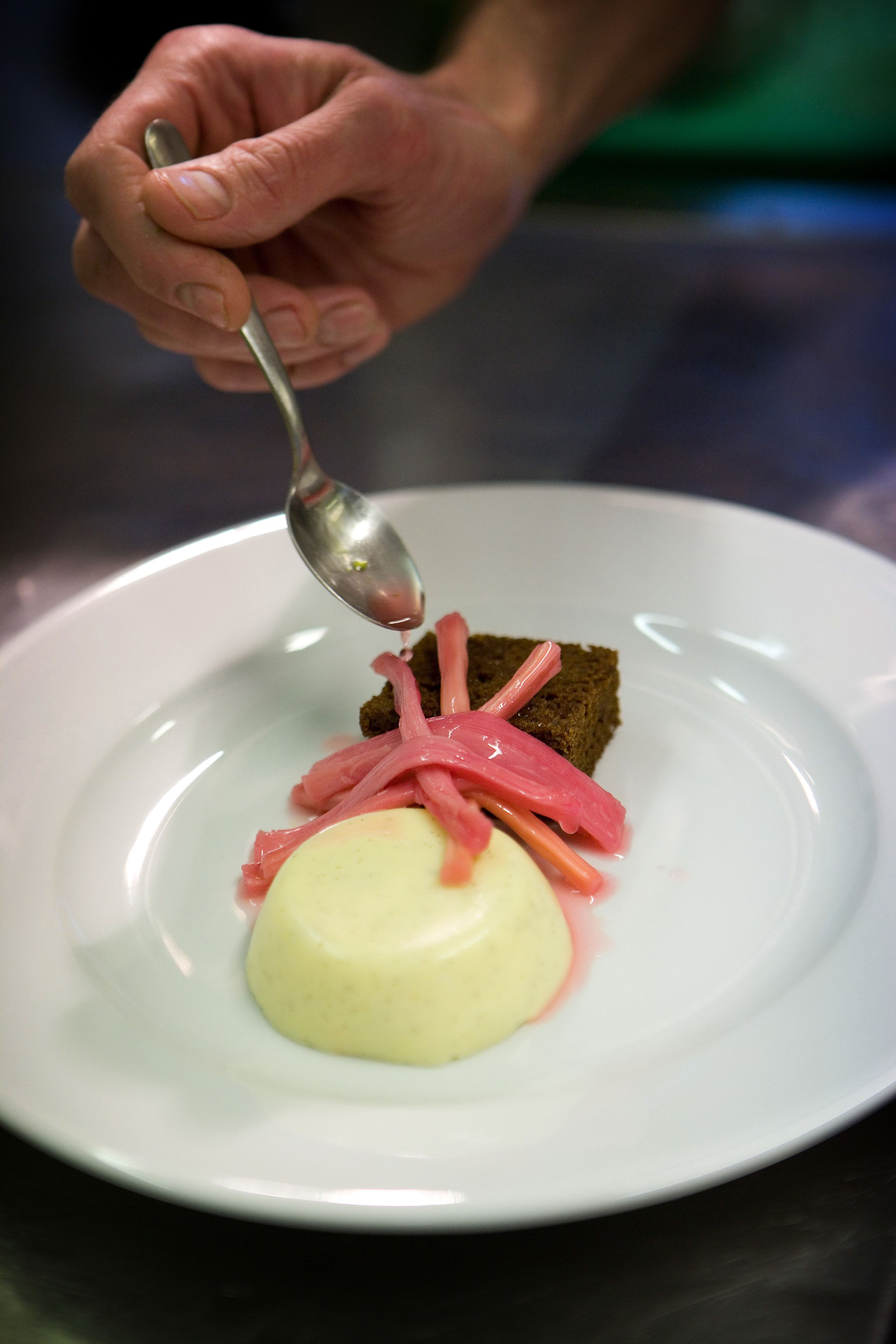 A dessert on a white plate with a spoon.