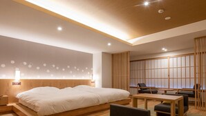 Une chambre d’hôtel moderne dotée d’un grand lit, d’un bureau et d’un coin salon.