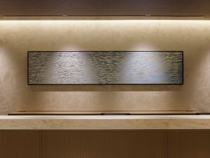 A wall-mounted flat-screen TV with a textured background.