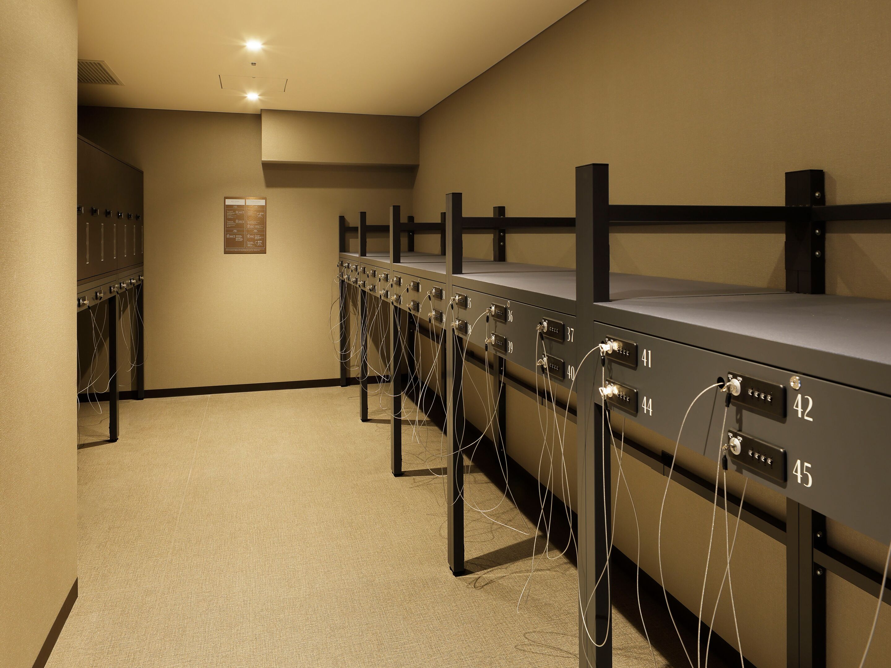 A row of bunk beds with individual electrical outlets numbered 36 to 45.