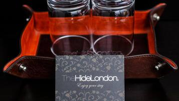 A tray with three glasses and a card labeled "TheHideLondon."