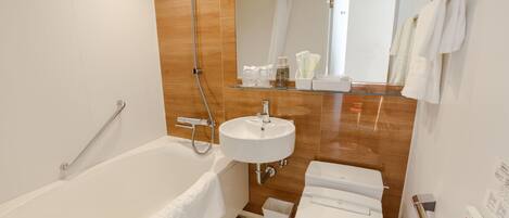 A modern bathroom with a bathtub, a sink, and a toilet.