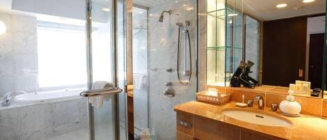 A modern bathroom with a glass-enclosed shower, a standalone bathtub, and a vanity with a large mirror.