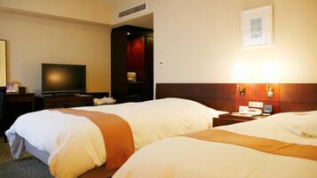 A hotel room with two beds, a television, a desk, and a nightstand.