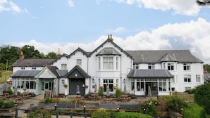 A white building with a pub named "The White Rabbit" and outdoor seating. - White Rabbit Hotel by Chef and Brewer Collection (Lyndhurst)