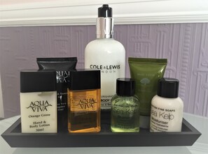 A display of various personal care products including hand and body lotion, body wash, shampoo, and conditioner. - Longmead House (Lynton)