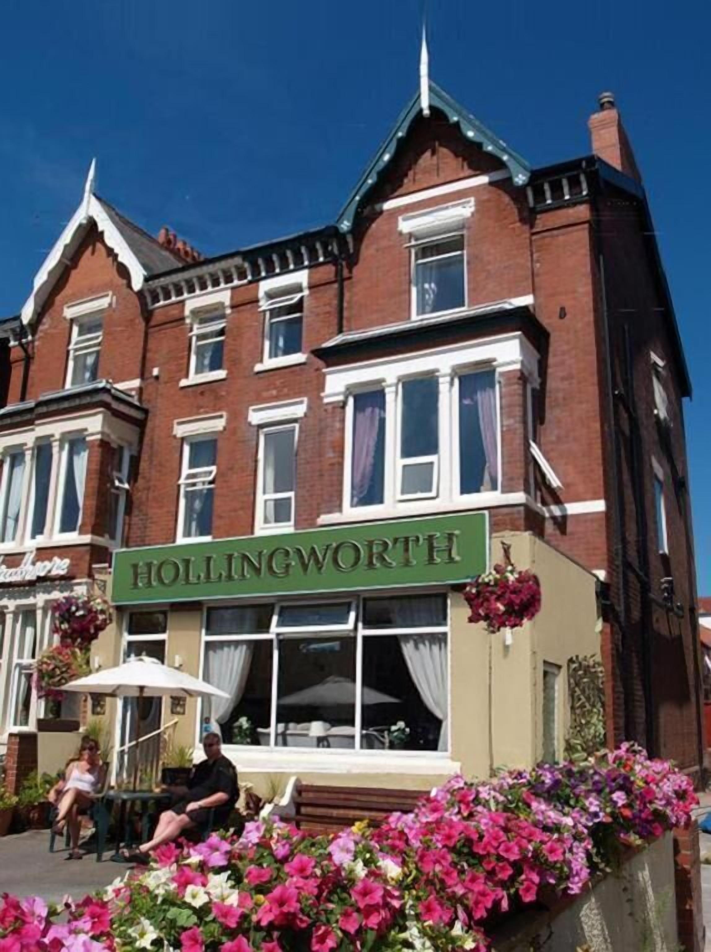A building with a green sign reading 'HOLLINGWORTH.'