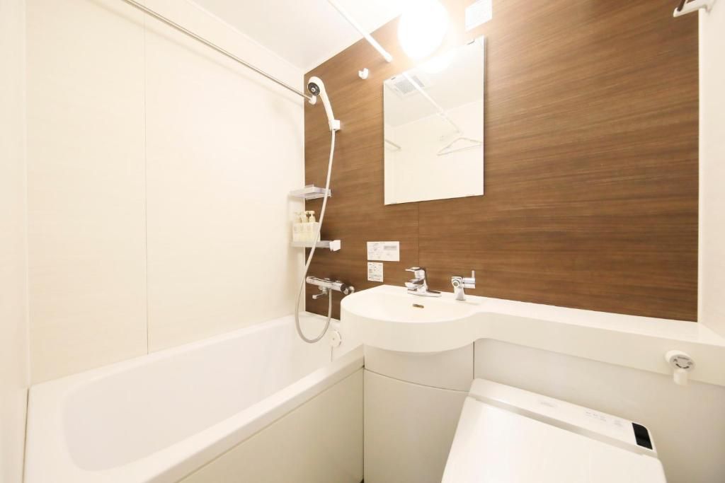 A modern bathroom with a bathtub, a sink, and a shower.