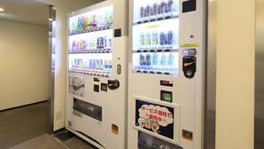 Two vending machines in a hallway with various beverages and snacks. - Hotel Shinjukuya (Machida)