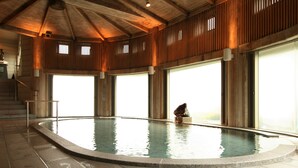 An indoor swimming pool with a wooden ceiling and large windows. - Zazan Minakami (Minakami)