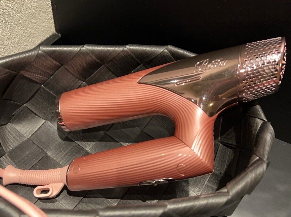 A pair of metallic, ribbed, curved objects in a woven basket.