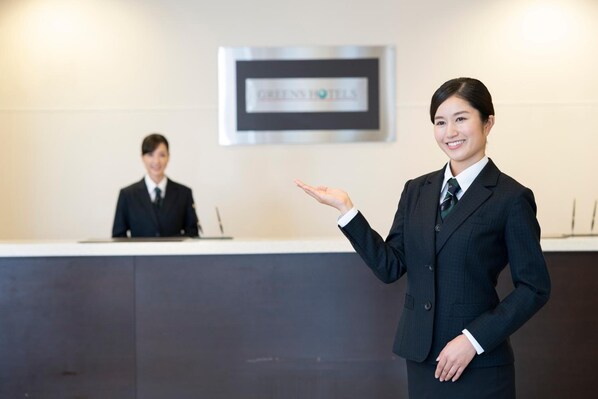A hotel reception area with a reception desk and a framed sign above it. - Iga Ueno City Hotel (Iga)
