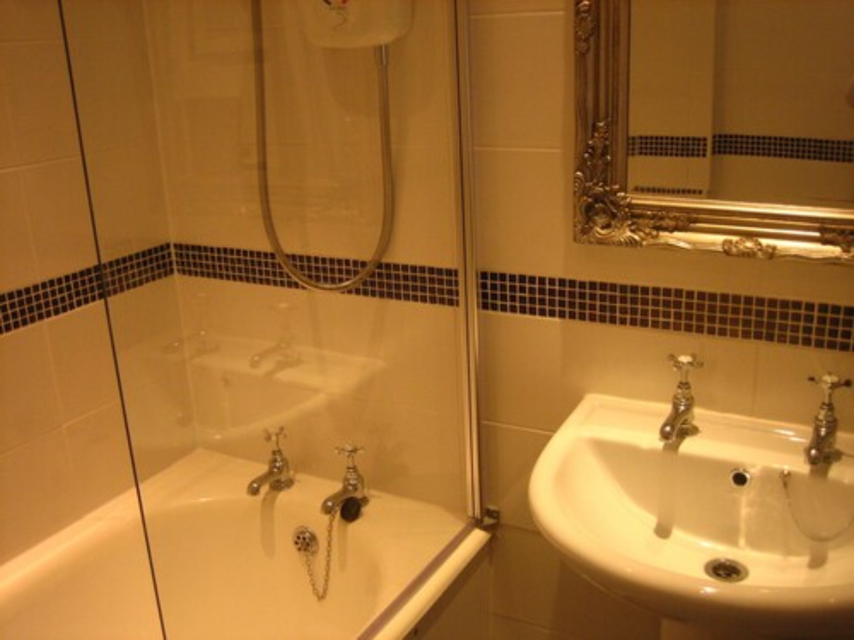 A bathroom with a bathtub, a sink, and a shower.