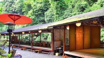 A traditional Japanese ryokan with tatami mat flooring and wooden structures.