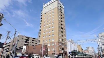 A high-rise building with multiple floors and a sign indicating it is a hotel.