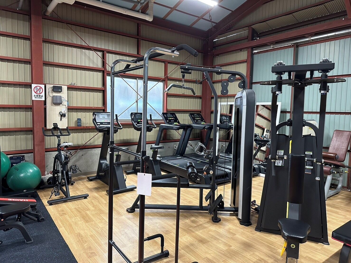 A gym with treadmills, weight machines, and exercise balls.