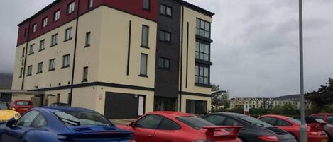 A multi-story building with a parking lot.