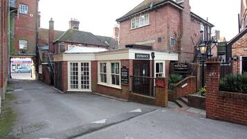 A brick building with a sign reading "Entrance" and "The Real White Hart" indicating a pub or restaurant.