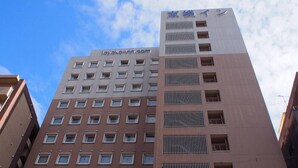 A multi-story hotel building with a modern design, featuring a mix of window styles and balconies. - Toyoko Inn Kagoshima Chuo-eki Nishi-guchi (KAGOSHIMA)