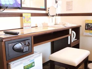 A hotel reception area with a desk, a refrigerator, a microwave, a television, and a mirror. - Toyoko Inn Kagoshima Chuo-eki Nishi-guchi (KAGOSHIMA)